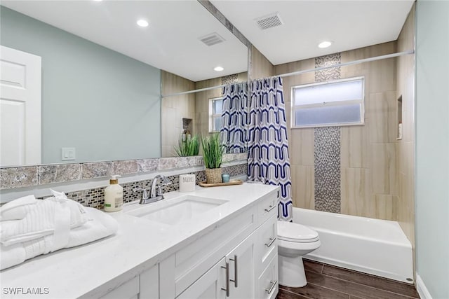 851 102nd Ave N, Naples, FL 34108 - full bathroom featuring vanity, shower / bath combo, wood finished floors, backsplash, and recessed lighting