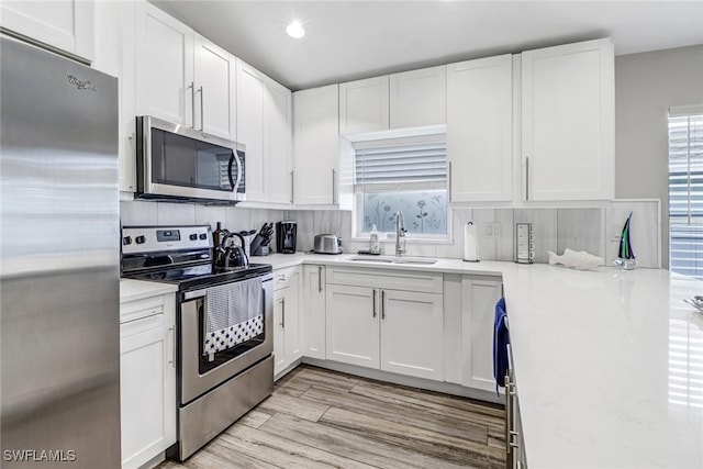 851 102nd Ave N, Naples, FL 34108 - kitchen featuring appliances with stainless steel finishes, white cabinetry, light countertops, and recessed lighting