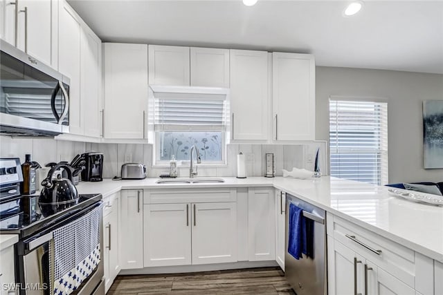 851 102nd Ave N, Naples, FL 34108 - kitchen with appliances with stainless steel finishes, recessed lighting, white cabinetry, light countertops, and dark wood-style flooring