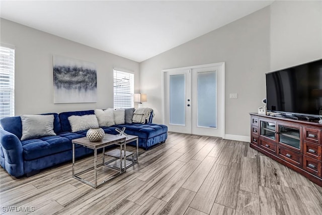 851 102nd Ave N, Naples, FL 34108 - living area featuring vaulted ceiling, light wood-style flooring, plenty of natural light, and french doors