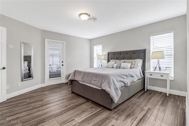 851 102nd Ave N, Naples, FL 34108 - bedroom with wood finished floors and access to exterior