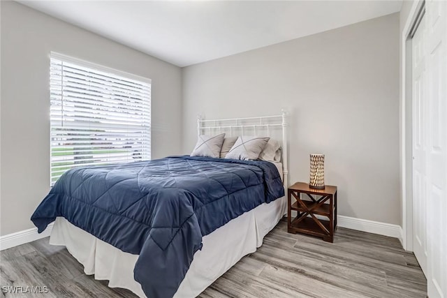 851 102nd Ave N, Naples, FL 34108 - bedroom featuring baseboards and wood finished floors