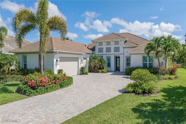 3187 Cotuit Ln, Naples, FL 34114 - mediterranean / spanish-style home with stucco siding, a tile roof, a garage, and decorative driveway