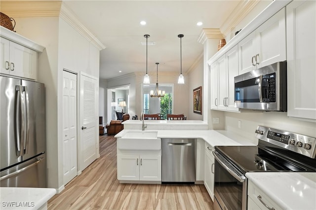 700 L Ambiance Cir Unit 202, Naples, FL 34108 - kitchen featuring stainless steel appliances, ornamental molding, light wood-type flooring, a peninsula, and recessed lighting