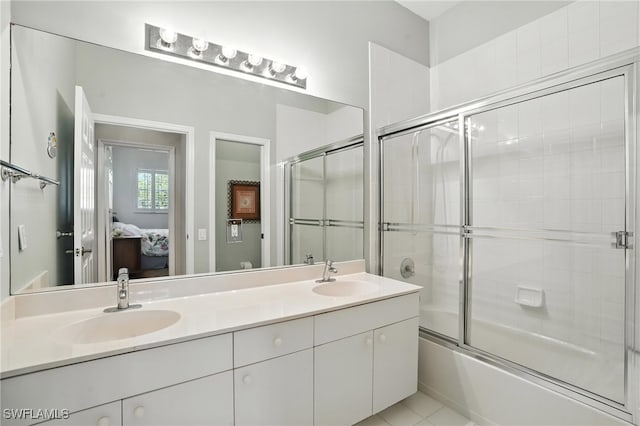 700 L Ambiance Cir Unit 202, Naples, FL 34108 - ensuite bathroom featuring double vanity and bath / shower combo with glass door