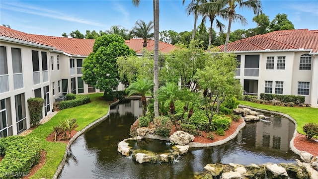 700 L Ambiance Cir Unit 202, Naples, FL 34108 - surrounding community featuring a garden pond