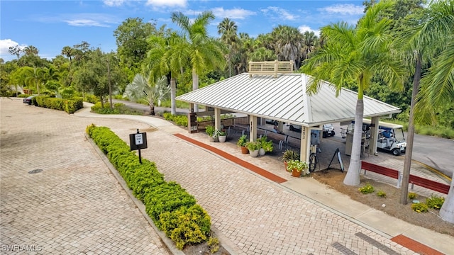700 L Ambiance Cir Unit 202, Naples, FL 34108 - view of community featuring a gazebo, view of wooded area, and parking