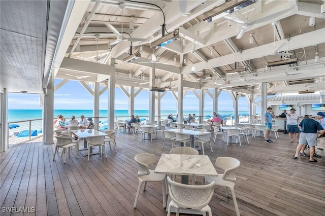 700 L Ambiance Cir Unit 202, Naples, FL 34108 - wooden terrace featuring a water view and outdoor dining space