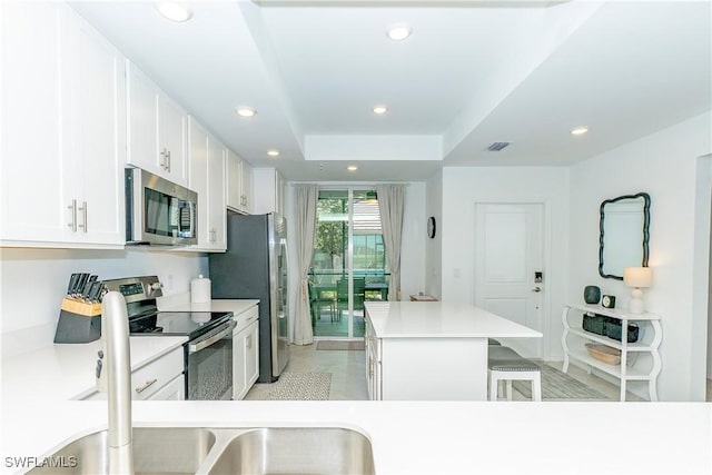 5467 Double Eagle Cir Unit 3212, Ave Maria, FL 34142 - kitchen with appliances with stainless steel finishes, a center island, recessed lighting, white cabinetry, and light countertops
