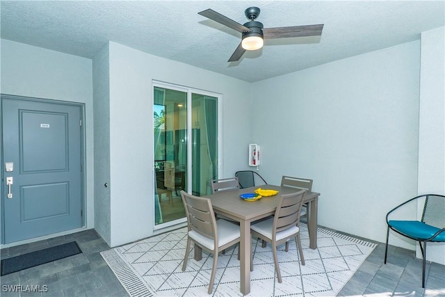 5467 Double Eagle Cir Unit 3212, Ave Maria, FL 34142 - dining space with a ceiling fan and a textured ceiling