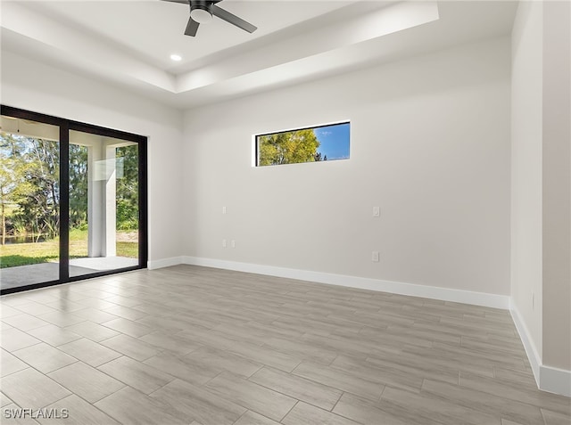 1159 SW 5th Ter, Cape Coral, FL 33991 - empty room featuring a raised ceiling, plenty of natural light, ceiling fan, and recessed lighting