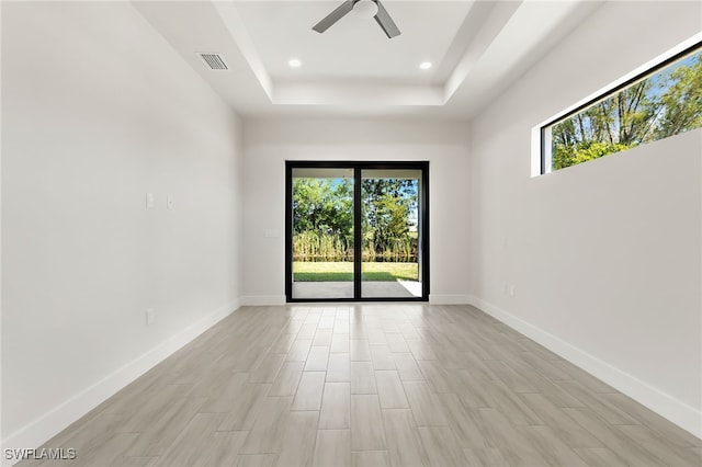 1159 SW 5th Ter, Cape Coral, FL 33991 - unfurnished room featuring ceiling fan, a tray ceiling, recessed lighting, and light wood-style floors