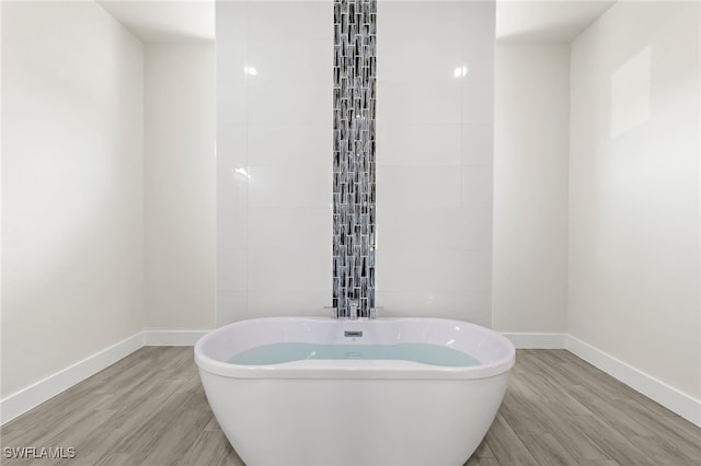 1159 SW 5th Ter, Cape Coral, FL 33991 - full bath with a freestanding tub and wood finished floors