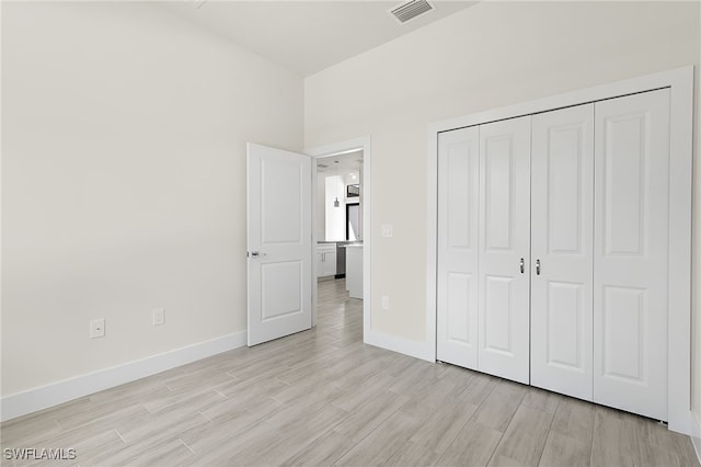 1159 SW 5th Ter, Cape Coral, FL 33991 - unfurnished bedroom with light wood-type flooring and a closet