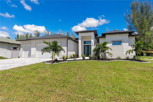1159 SW 5th Ter, Cape Coral, FL 33991 - prairie-style home with stucco siding, an attached garage, decorative driveway, and a front lawn