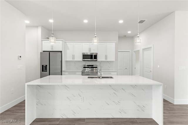 1159 SW 5th Ter, Cape Coral, FL 33991 - kitchen featuring appliances with stainless steel finishes, a spacious island, white cabinets, recessed lighting, and backsplash