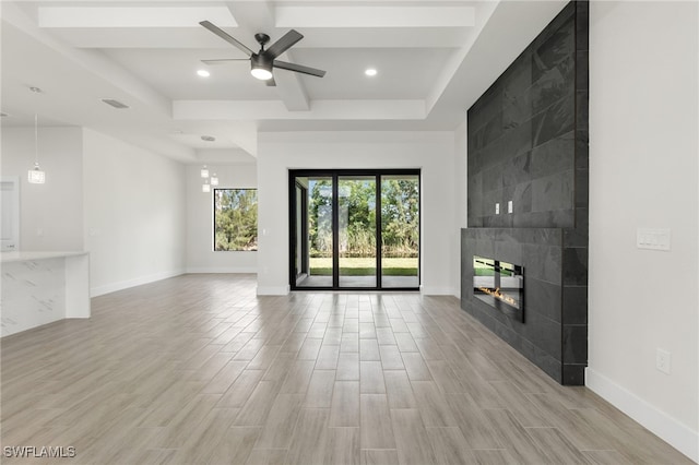 1159 SW 5th Ter, Cape Coral, FL 33991 - unfurnished living room featuring a ceiling fan, light wood-style flooring, a tiled fireplace, and recessed lighting