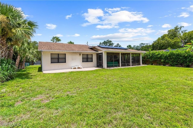 27780 Matheson Ave, Bonita Springs, FL 34135 - back of house with a sunroom, a patio area, roof mounted solar panels, a yard, and stucco siding