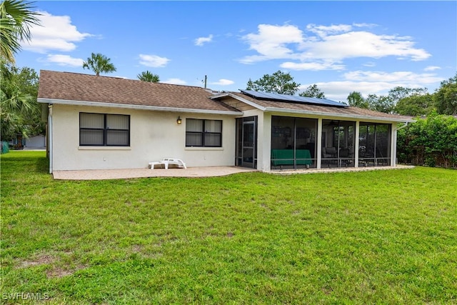 27780 Matheson Ave, Bonita Springs, FL 34135 - rear view of property with a sunroom, solar panels, stucco siding, a lawn, and a patio area