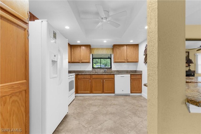 27780 Matheson Ave, Bonita Springs, FL 34135 - kitchen with white appliances, a ceiling fan, a raised ceiling, brown cabinets, and recessed lighting