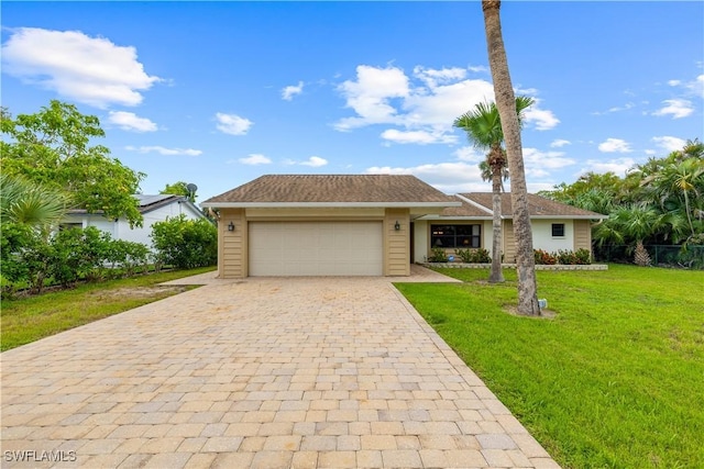 27780 Matheson Ave, Bonita Springs, FL 34135 - view of front of property with decorative driveway, a garage, and a front lawn