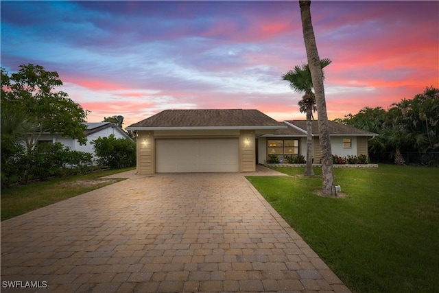 27780 Matheson Ave, Bonita Springs, FL 34135 - view of front of home with decorative driveway, an attached garage, and a yard