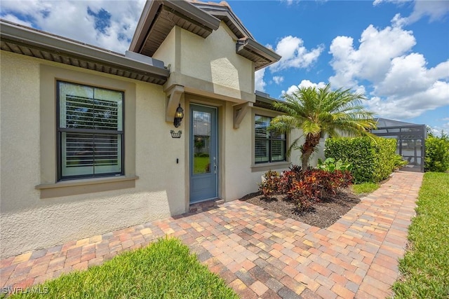 7773 Jacaranda Ln, Naples, FL 34114 - view of exterior entry featuring stucco siding
