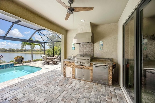 7773 Jacaranda Ln, Naples, FL 34114 - view of patio / terrace featuring exterior kitchen, a water view, ceiling fan, glass enclosure, and an outdoor pool