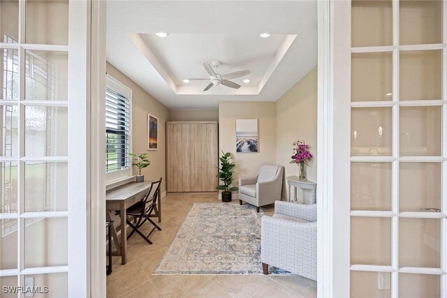 7773 Jacaranda Ln, Naples, FL 34114 - foyer entrance featuring a ceiling fan, recessed lighting, tile patterned flooring, and a tray ceiling
