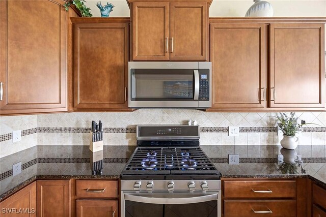 7773 Jacaranda Ln, Naples, FL 34114 - kitchen featuring stainless steel appliances, brown cabinetry, and backsplash