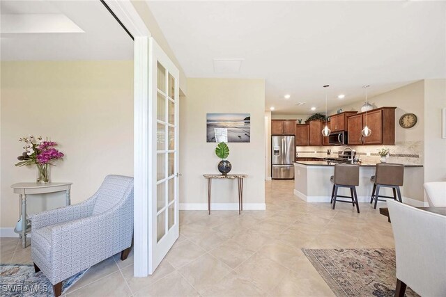 7773 Jacaranda Ln, Naples, FL 34114 - living area with light tile patterned floors and recessed lighting