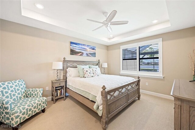 7773 Jacaranda Ln, Naples, FL 34114 - bedroom with a tray ceiling, light carpet, recessed lighting, and a ceiling fan