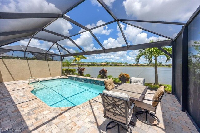 7773 Jacaranda Ln, Naples, FL 34114 - swimming pool with a water view, a patio area, and glass enclosure