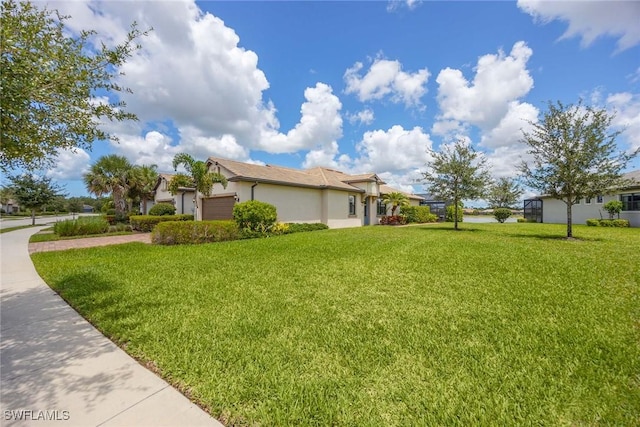 7773 Jacaranda Ln, Naples, FL 34114 - view of side of property featuring a yard, an attached garage, driveway, and stucco siding