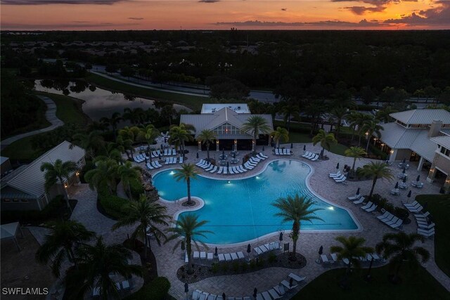 7773 Jacaranda Ln, Naples, FL 34114 - community pool with a patio and a water view