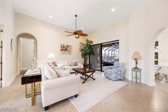 3820 Ruby Way, Naples, FL 34114 - living area featuring arched walkways, ceiling fan, high vaulted ceiling, recessed lighting, and light tile patterned flooring