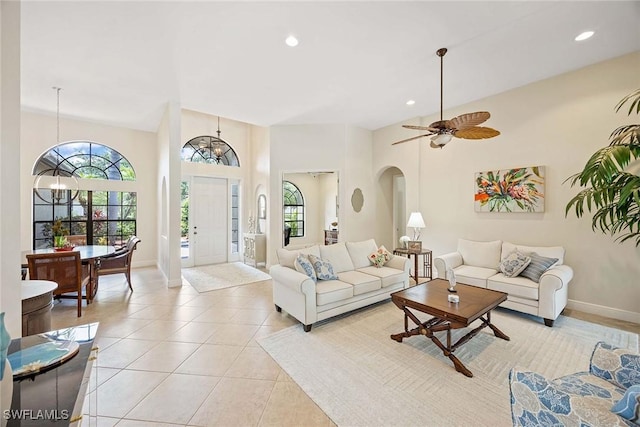 3820 Ruby Way, Naples, FL 34114 - living room with arched walkways, recessed lighting, and light tile patterned flooring