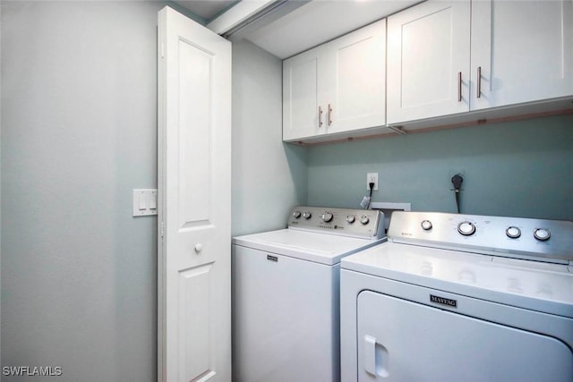 8849 Somerset Blvd, Fort Myers, FL 33919 - washroom with cabinet space and washing machine and dryer