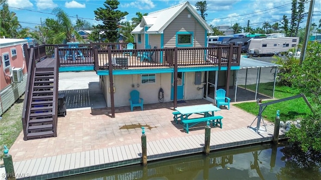 2595 Pine St, Matlacha, FL 33993 - rear view of house with stairway, a patio area, a wooden deck, and stucco siding