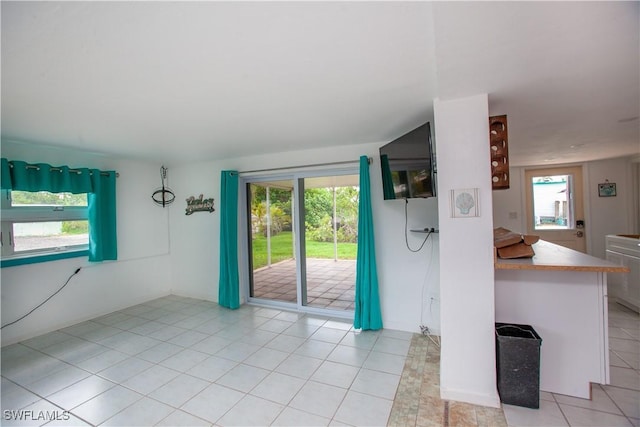 2595 Pine St, Matlacha, FL 33993 - unfurnished living room with plenty of natural light and light tile patterned floors
