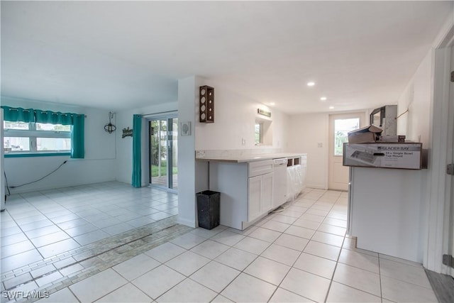 2595 Pine St, Matlacha, FL 33993 - kitchen featuring light tile patterned flooring, white cabinets, white dishwasher, plenty of natural light, and recessed lighting