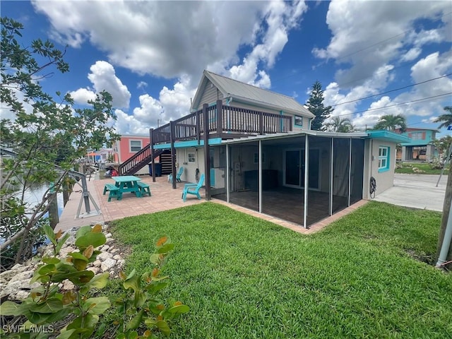 2595 Pine St, Matlacha, FL 33993 - back of property with a patio, stairs, a sunroom, a yard, and a wooden deck