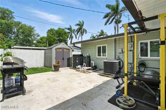 1423 Charles Rd, Fort Myers, FL 33919 - view of patio with a storage unit and a grill