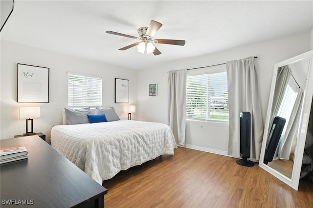 1423 Charles Rd, Fort Myers, FL 33919 - bedroom featuring multiple windows, wood finished floors, and a ceiling fan