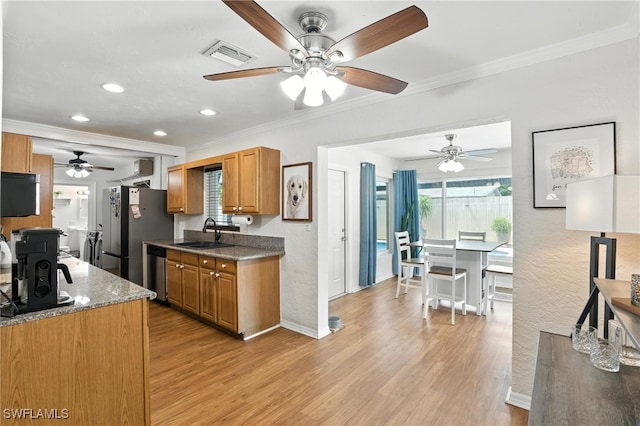 1423 Charles Rd, Fort Myers, FL 33919 - kitchen with stainless steel appliances, a ceiling fan, light wood-style flooring, crown molding, and recessed lighting