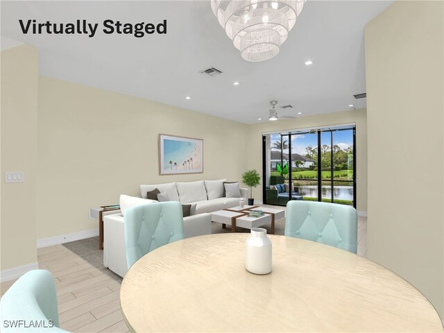 7524 Carnegie Way, Naples, FL 34119 - dining space with a chandelier, recessed lighting, light wood-style flooring, and a water view