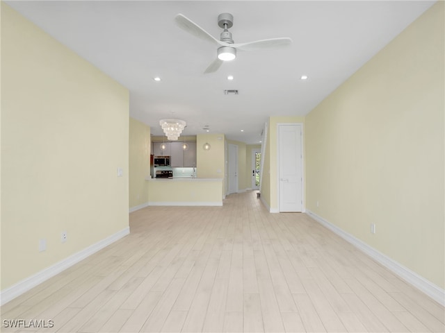 7524 Carnegie Way, Naples, FL 34119 - unfurnished living room with light wood-type flooring, a ceiling fan, a chandelier, and recessed lighting