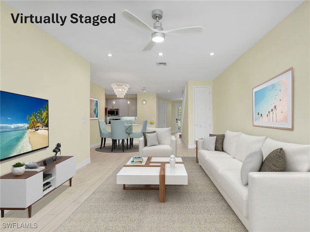 7524 Carnegie Way, Naples, FL 34119 - living room with wood finished floors, recessed lighting, a ceiling fan, and a chandelier