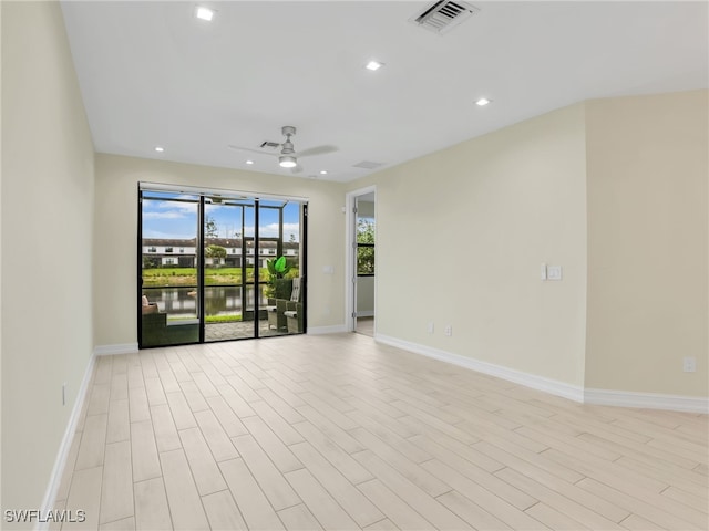 7524 Carnegie Way, Naples, FL 34119 - empty room with ceiling fan, recessed lighting, light wood finished floors, and a water view