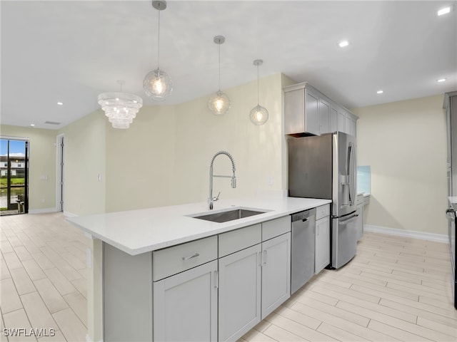 7524 Carnegie Way, Naples, FL 34119 - kitchen with stainless steel appliances, gray cabinetry, light countertops, a peninsula, and recessed lighting